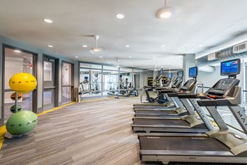 a gym with treadmills and other exercise equipment